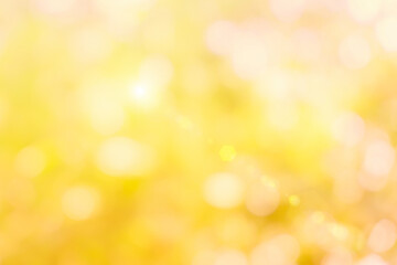Natural yellow background blurring warm colors and bright gold sunlight. Bokeh or Christmas...