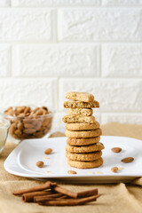 Stack of Gluten Free Almond Cookies set on white cafe table.