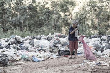  Children find junk for sale and recycle them in landfills, the lives and lifestyles of the poor, Child labor, Poverty and Environment Concepts