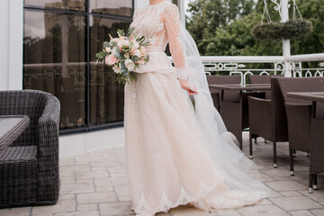 the bride in a wedding dress holds a bouquet