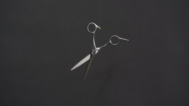 Levitating hair scissors flying scissors black background