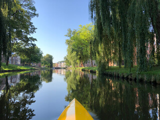 Fototapeta na wymiar Canoeing at the canal around the old town of Sneek