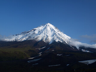 Archive photo, 2008: Koryaksky volcano on a blue sky with clouds, Kamchatka Peninsula.