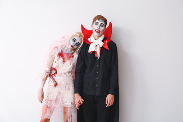 Friends in Halloween costumes on white background