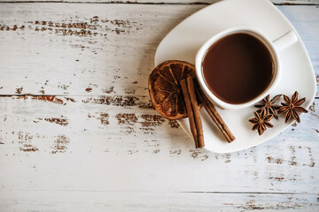 Coffee cup with spices on wooden table texture