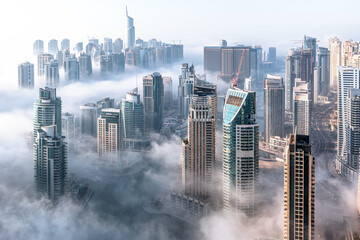 Aerial view of Dubai skyline. Morning mist hovering Dubai Marina - Powered by Adobe