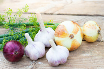 onion and garlic on vintage wooden background, harvesting. Healthy food, vitamins