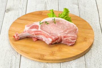 Raw pork bone steak over wooden