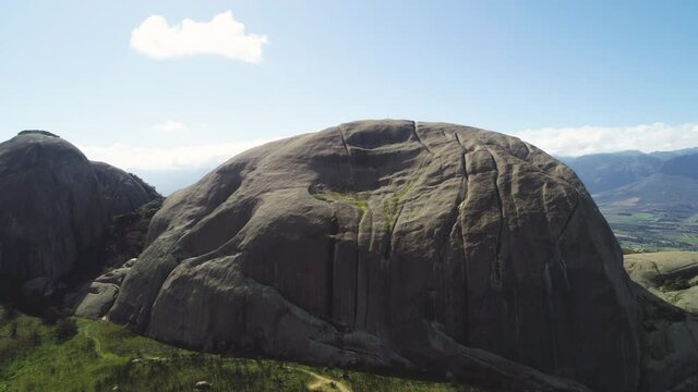 Aerial - Massive granite monolith of Paarl Mountain, South Africa, rising revealing shot
