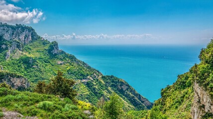 A panoramic view of the steep, terraced vineyards and dramatic coastline of the Amalfi Coast in...