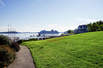 Modern luxury cruiseship or cruise ship liner anchoring on blue sea in bay offshore of Bar Harbor,...