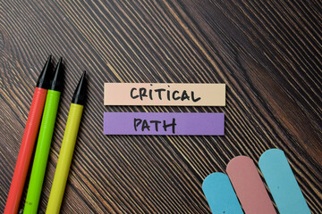 Critical Path write on sticky notes isolated on office desk.