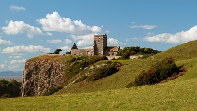 Slow motion POV walk towards the stunning Old Church of St Nicholas at Uphill, Somerset, England, UK dating from around 1080