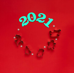 Numbers 2021 with cookie forms on a red background. Screensaver for the New year.