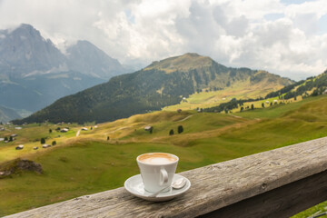 Coffee cup in coffee time on mountain view background, Dolotites, Italy