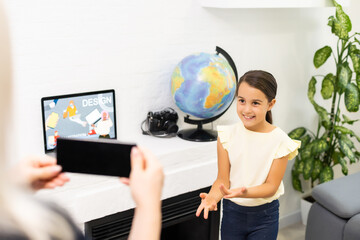 Video contest. Little beautiful girl with long dark hair making little video presentation while participating in beauty contest