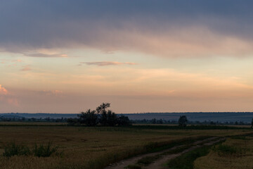 Panorama. Landscape with bloody sunset. The eerie clouds had invaded the sky. Storm front over the...
