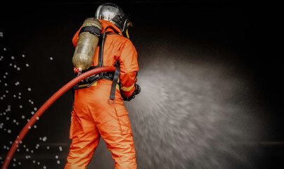 Fireman training Spray water curtain ,The Back side view of a group of firefighters helped stop the...