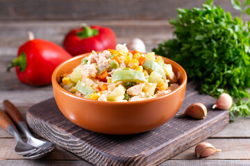Stewed vegetable stew in a ceramic bowl on wooden table