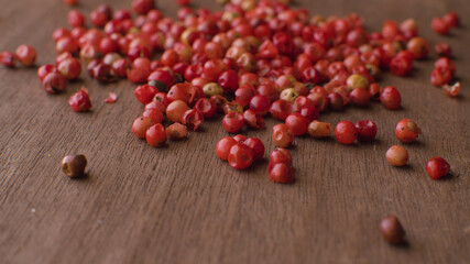 Red peppercorns on the wooden table