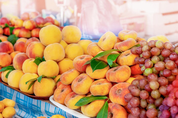 harvest of ripe juicy flat peaches is on the counter of the farmers ' market. harvest is for sale