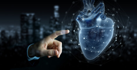 Man hand using digital x-ray of human heart holographic scan projection 3D rendering