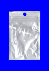 A blank white plastic bag, used to protect small items before shipping or selling; isolated on a blue surface; an empty canvas for your own creativity.
