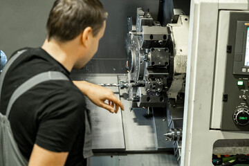 a man works at a laser cutting factory near a machine. High quality photo