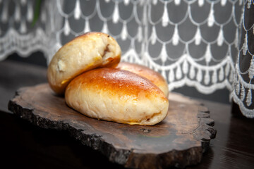 Freshly baked pies on a glass stand with a napkin. Close-up of baked pies