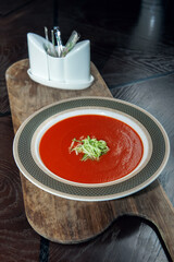 Gazpacho diet tomato soup with herbs and cucumber on a plate