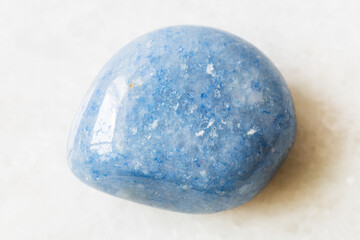 closeup of sample of natural mineral from geological collection - polished blue Aventurine gem...