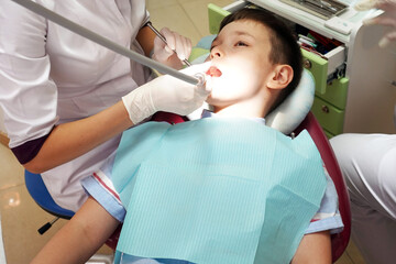 Dentist examining boy mouth