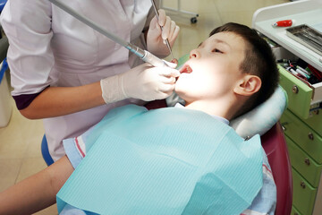 Dentist examining boy mouth