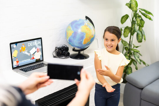 Video contest. Little beautiful girl with long dark hair making little video presentation while participating in beauty contest