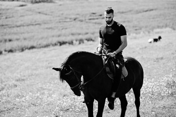 Arab tall beard man wear in black ride arabian horse.