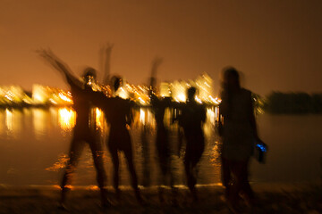 People silhouettes on the night beach