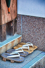 Obraz na płótnie Canvas Two pairs of Traditional Japanese Sabot Sandals Near The Shrine Entrance on Mount Koyasan.