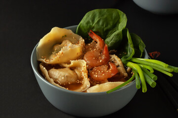 Shrimp noodle soup with wontons and spinach