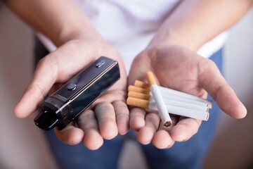 Man holding a cigarette, focus hand