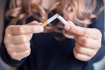 Women quit smoking for health, hand focus