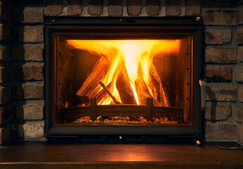 fireplace and fire close view as object or background, brick wall