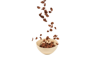 Chocolate corn flakes falling to the white bowl isolated on white. Motion.