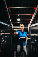 Fototapeta na wymiar Fitness woman on bicycle doing cardio workout at gym