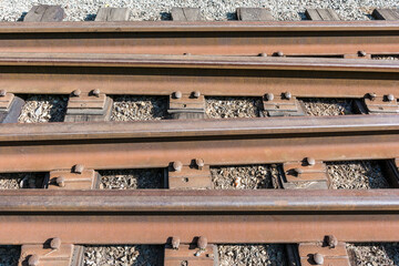 rusty rails on an abandoned railway are installed on wooden sleepers