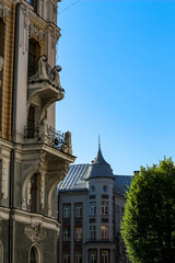 Fototapeta premium Exteriors of old buildings with balcony and decorations