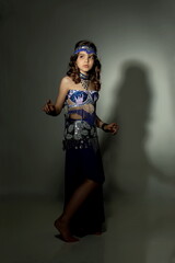 Beautiful teen girl in a blue suit oriental dance