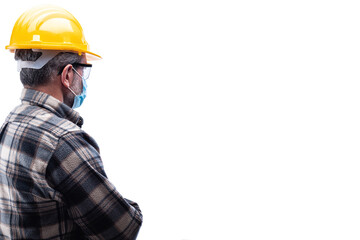 Carpenter worker isolated on white background, wears helmet, goggles, leather gloves and surgical mask to prevent coronavirus infection. Preventing Pandemic Covid-19 at the workplace.