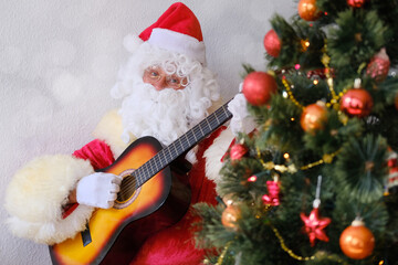 santa claus with white beard holding a guitar, playing and singing, christmas concept, waiting for gifts, new year celebration