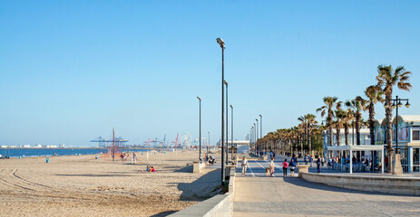 Valencia, Spain: Paseo Maritimo with a view on the beach, the promenade and harbour installations on the horizon 