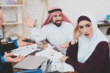 Arab girl turned away from her husband who yells.